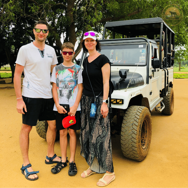 Tourists enjoying a guided wildlife safari in an open-top jeep